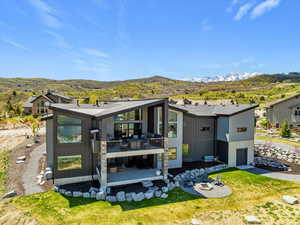 Rear view of house featuring a deck with mountain view