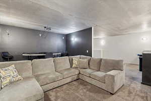 Carpeted home theater with a textured ceiling