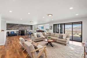 Living room featuring light wood finished floors, recessed lighting, and a mountain view