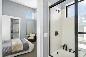 Ensuite bathroom featuring enclosed tub / shower combo and carpet floors