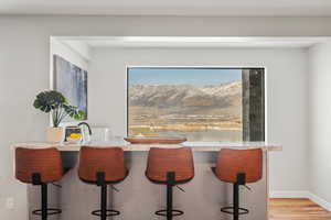 Dining space with a mountain view and light wood-style floors