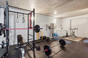Workout area featuring dark flooring