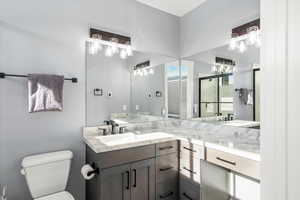 Full bathroom with toilet and vanity