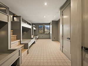 Corridor featuring light colored carpet and recessed lighting