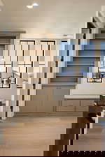 Interior space with a textured ceiling, a mountain view, light wood-type flooring, built in shelves, and recessed lighting