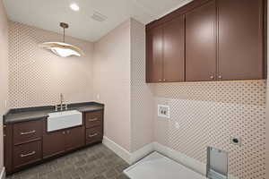 Laundry area featuring cabinet space, hookup for a washing machine, recessed lighting, wallpapered walls, and electric dryer hookup