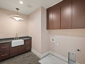 Laundry area featuring cabinet space, hookup for a washing machine, recessed lighting, wallpapered walls, and electric dryer hookup