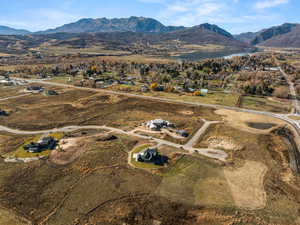 Aerial view of property and surrounding area featuring a water and mountain view