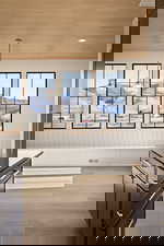 Unfurnished dining area featuring a mountain view, wooden ceiling, and light wood-style floors