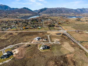 Aerial view of property and surrounding area featuring a water and mountain view
