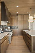 Kitchen with wooden ceiling, recessed lighting, premium range hood, stainless steel range, and light wood finished floors