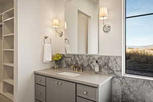 Bathroom with vanity and decorative backsplash