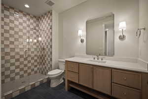 Full bathroom featuring vanity, a shower stall, recessed lighting, and dark tile patterned floors