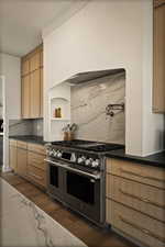 Kitchen featuring double oven range, decorative backsplash, dark wood-style flooring, and dark stone countertops