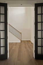 Hallway featuring dark wood-style floors and stairway