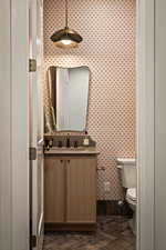 Bathroom featuring vanity and brick patterned floors