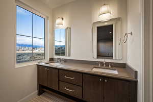 Full bathroom featuring double vanity and a mountain view