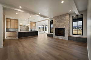 Living area with beamed ceiling, dark wood finished floors, a fireplace, and recessed lighting