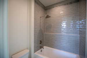 Full bath with shower / washtub combination and toilet