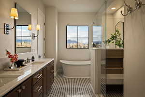 Full bath with double vanity, a soaking tub, a mountain view, and dark tile patterned floors