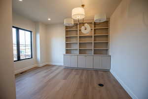Unfurnished dining area featuring light wood finished floors and recessed lighting