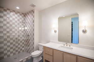 Bathroom with vanity, a shower stall, dark tile patterned flooring, and recessed lighting