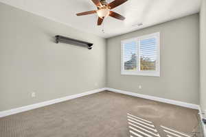 Spare room with carpet flooring, ceiling fan, and a textured ceiling