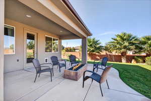 Fenced backyard featuring a patio and an outdoor fire pit