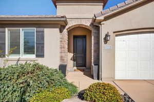 Property entrance with stucco siding and stone siding
