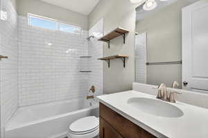 Bathroom featuring shower / tub combination and vanity
