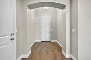 Doorway featuring wood finished floors and arched walkways