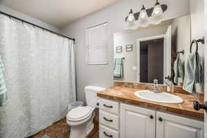 Bathroom with curtained shower and vanity