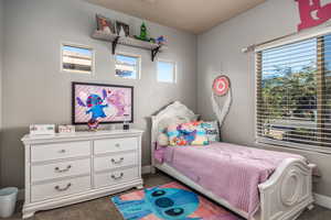 Carpeted bedroom with baseboards
