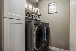 Laundry room featuring separate washer and dryer and wood finished floors