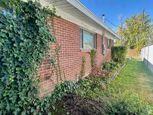 View of side of home featuring brick siding