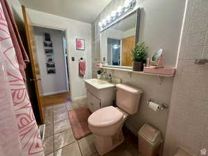 Full bathroom with vanity and baseboards