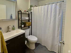 Bathroom featuring a shower with curtain, vanity, and dark wood-style flooring