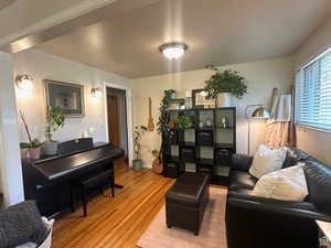 Living area featuring light wood-style flooring and baseboards