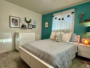 Bedroom with crown molding and baseboards
