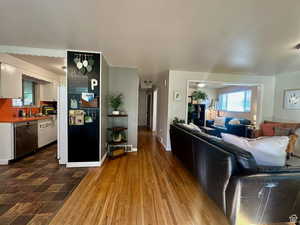 Living area featuring dark wood-type flooring and baseboards