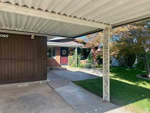 Covered porch featuring a yard