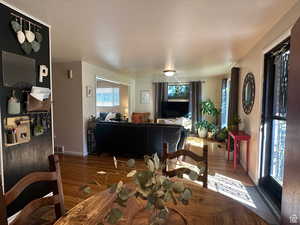 Dining space with wood finished floors and baseboards