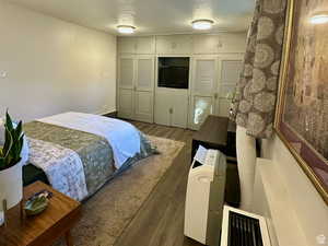 Bedroom with dark wood-style floors and a textured ceiling