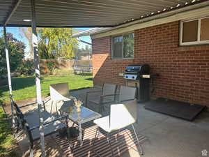 View of patio / terrace with a trampoline and area for grilling