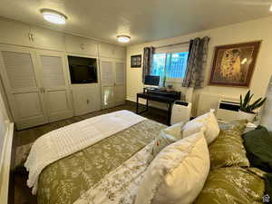 Bedroom with dark wood-style flooring