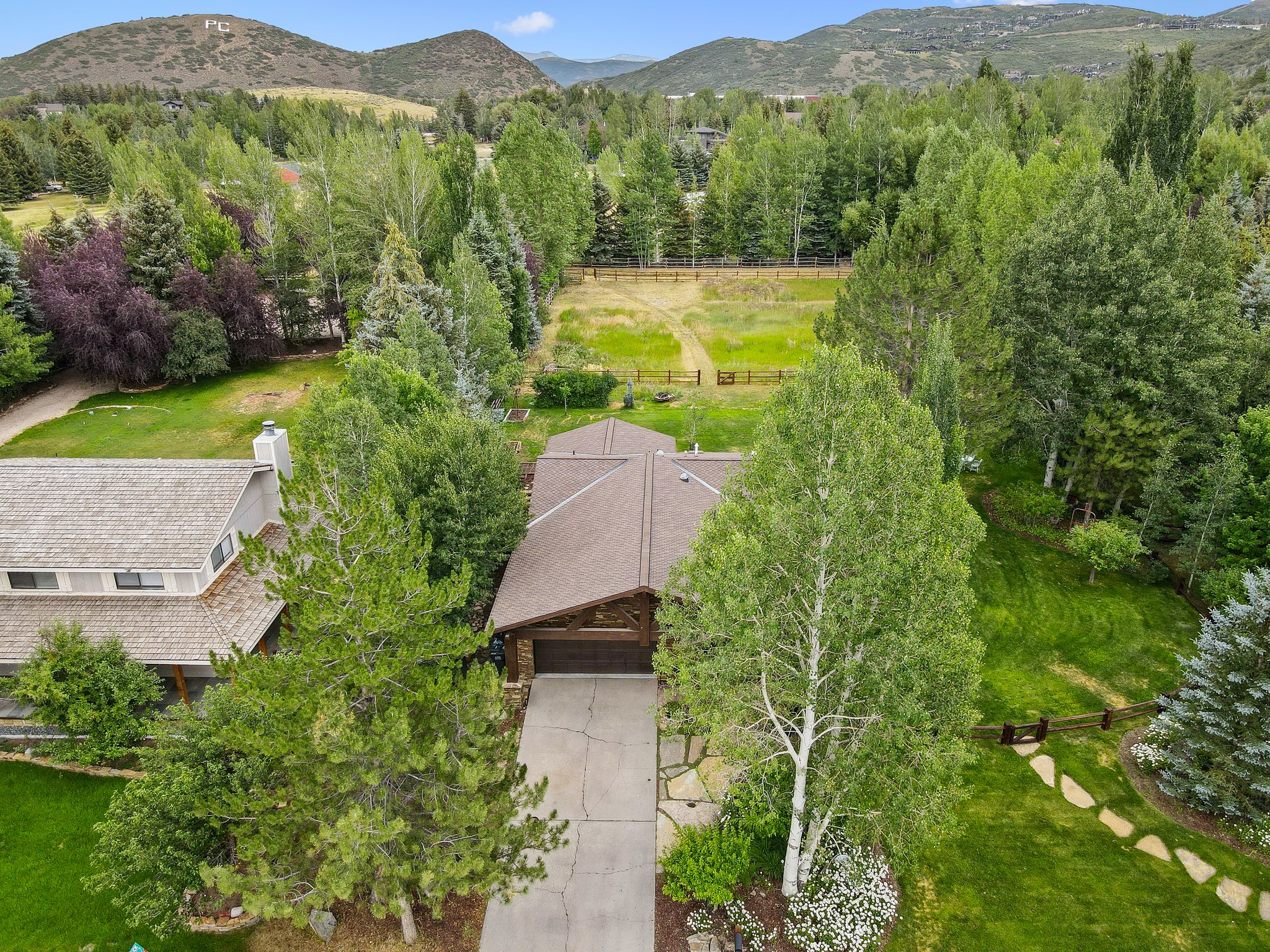 Aerial view of property and surrounding area with a mountainous background