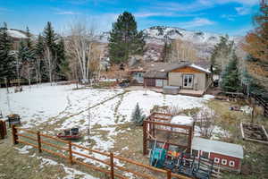Rear view of house featuring a mountain view and a patio area