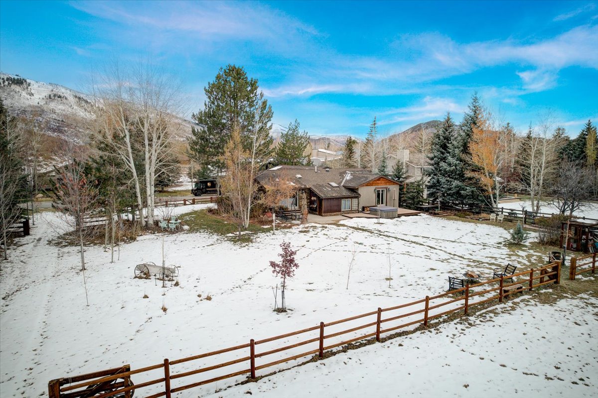 Snowy yard featuring a patio area and a mountain view