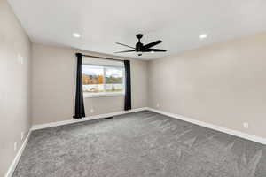 Empty room with light colored carpet, ceiling fan, and recessed lighting