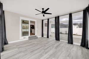 Spare room featuring light wood-style floors and ceiling fan